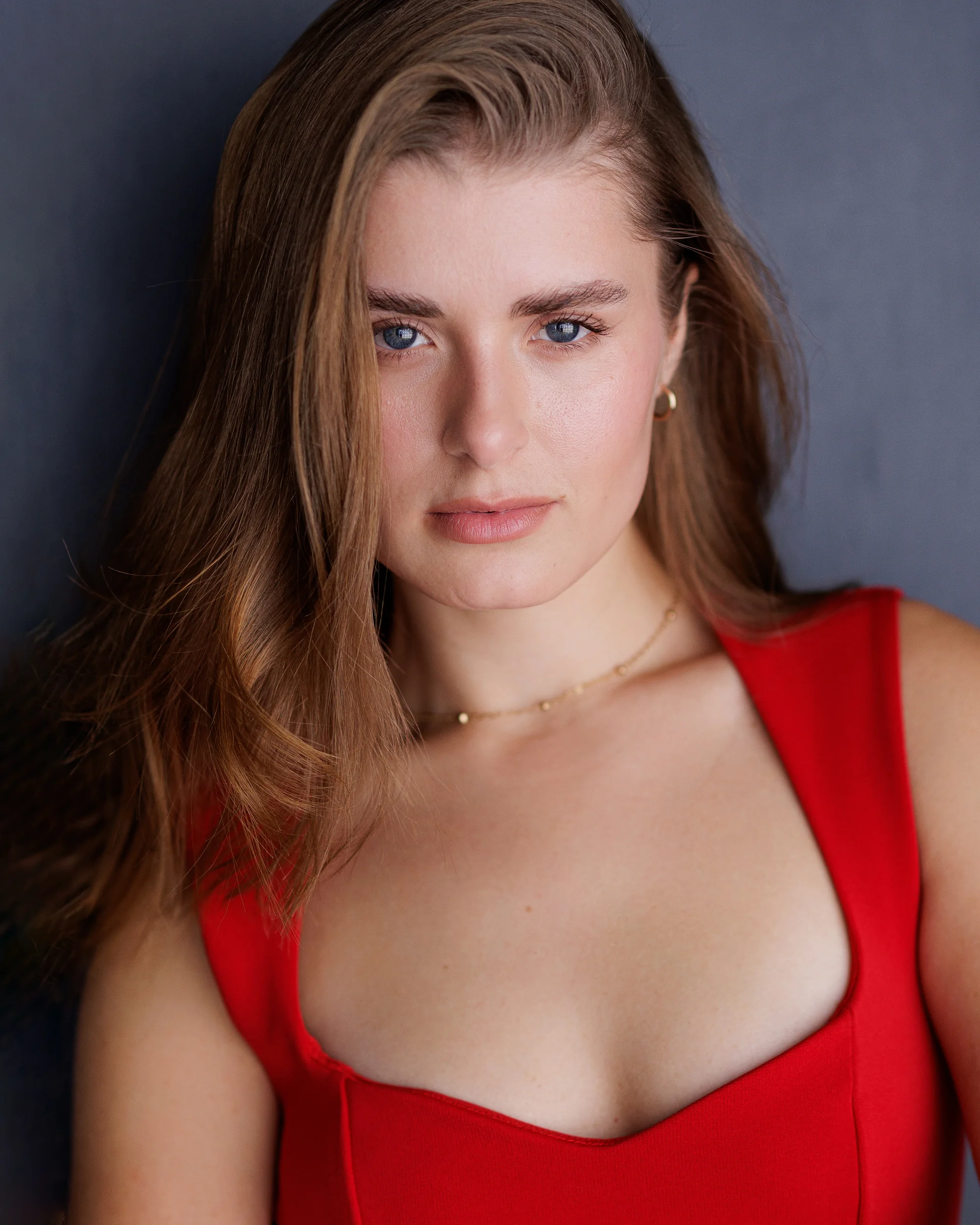 Close-up beauty portrait of Radhica Isac wearing a red top